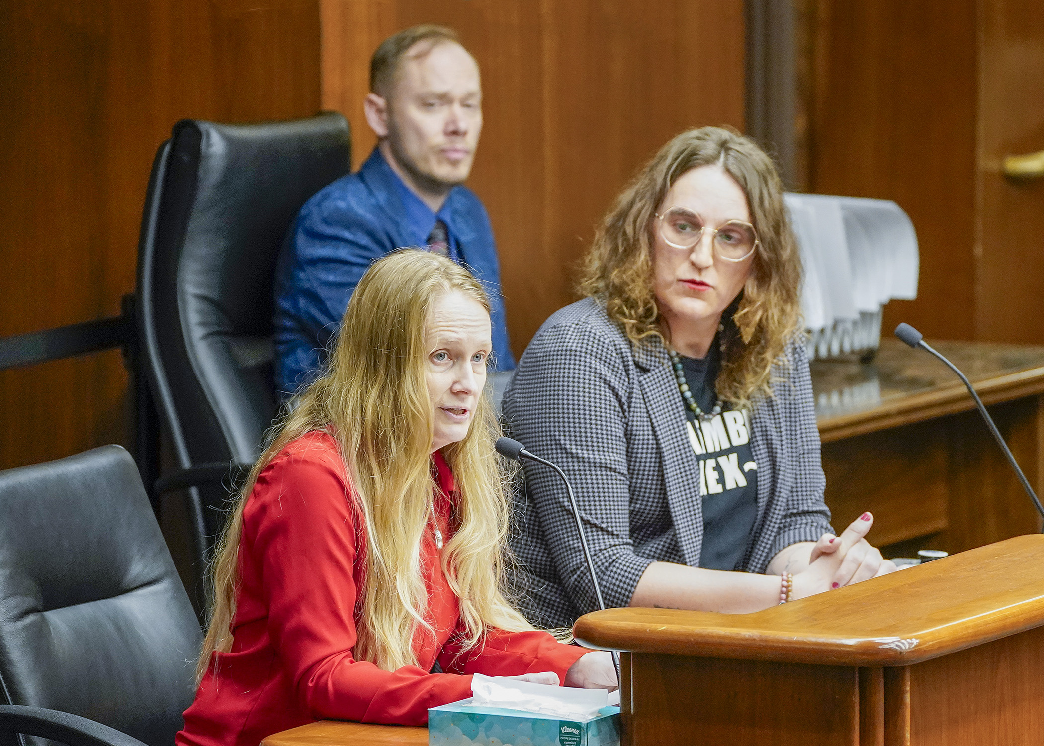 Holly Kathleen Bot testifies before the House Public Safety Finance and Policy Committee March 26 in support of a bill sponsored by Rep. Leigh Finke, right, that would, in part, expand visitation rights of incarcerated persons. (Photo by Andrew VonBank)